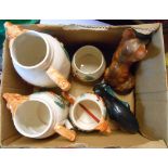 A box containing a small quantity of assorted ceramic items including Poole Pottery dolphin