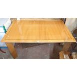 A 1.5m modern mixed wood extending dining table with stowed leaf, set on angled legs