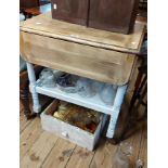 A vintage later part painted oak two tier tea trolley, set on turned supports and casters