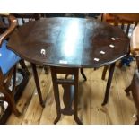 A 60cm Edwardian stained mahogany Sutherland table with shaped top, set on pierced standard ends