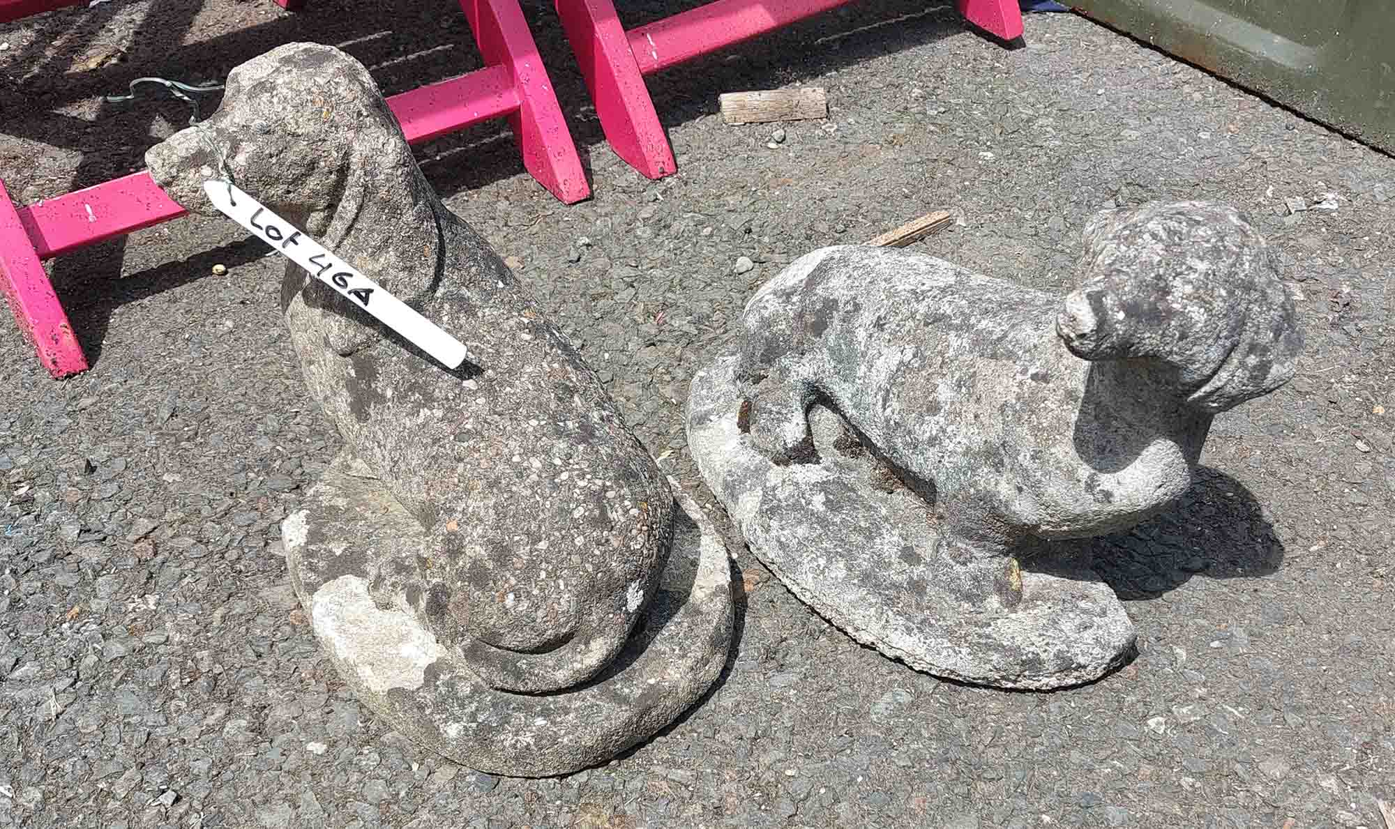 A pair of concrete dachshund pattern garden ornaments