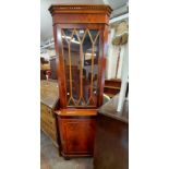 A 66cm reproduction mahogany corner cabinet with beaded glazed panel door to top and cupboard under,
