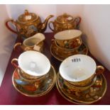 A 20th Century Japanese porcelain tea set with moriage and gilt decoration comprising teapot,