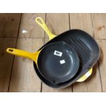 A Le Creuset griddle pan in the yellow colourway - sold with an unmarked similar frying pan