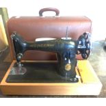 A vintage Singer electric sewing machine in original hard carry case