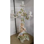 A large German porcelain table candelabrum with all-over flower encrusted decoration and set with