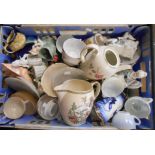 A crate containing a quantity of assorted ceramic and other items including figurines, jugs, cups