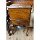 A 20th Century walnut lift-top sewing box with drawer under, set on cabriole legs with pad feet -