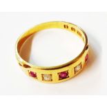 An antique 18ct. gold band, set with three tiny rubies interspersed with two diamonds - shank worn -