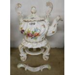 A German porcelain spirit kettle and stand in the Dresden style decorated with Rococo scrolling