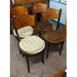 A set of four Art Nouveau bentwood kitchen chairs with printed floral decoration to top rails and