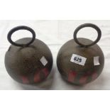 A pair of large modern door stops in antique weight form painted finish