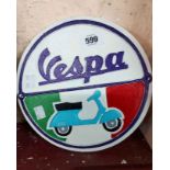 A modern painted cast iron Vespa sign