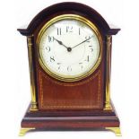 An Edwardian mahogany and strung timepiece with Arabic numerals and flanking slender brass