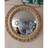 A vintage cream and parcel gilt painted plater framed convex wall mirror with decorative pierced
