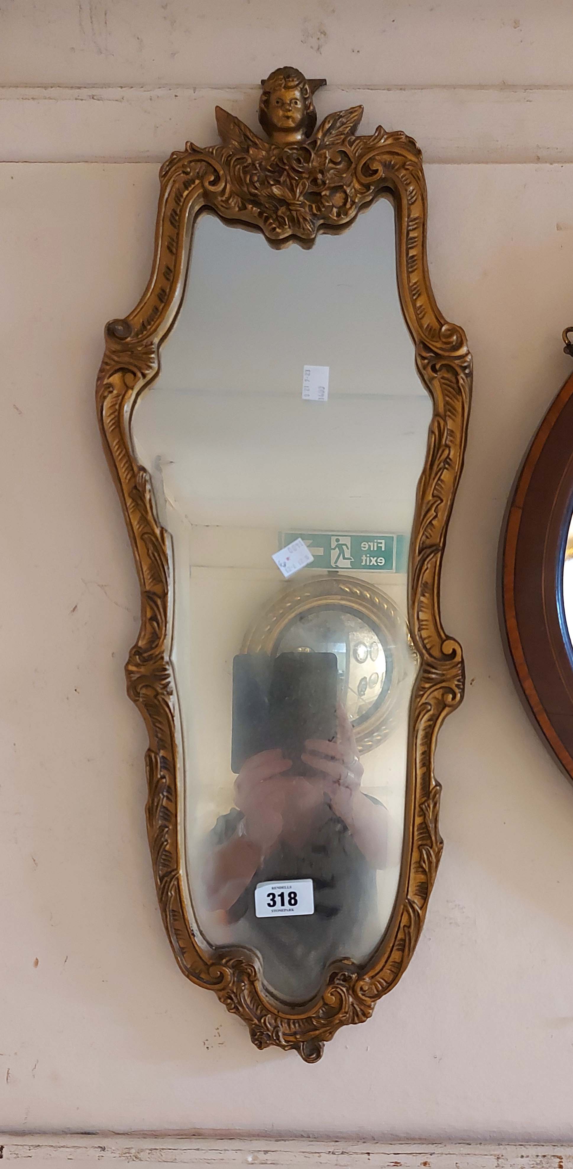 A small vintage Aisonea ornate gilt framed wall mirror with Rococo border and shaped plate