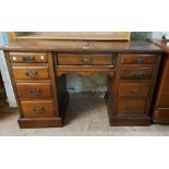 A 1.22m Edwardian walnut kneehole dressing table base with three frieze drawers and six flanking