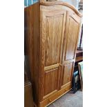 A 96cm modern pine double wardrobe with hanging space enclosed by a pair of panelled doors with long