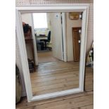 A modern white painted framed oblong wall mirror