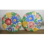 A pair of Art Deco Plichta (Bovey Tracey) wall masks of moulded floral form with boldly painted