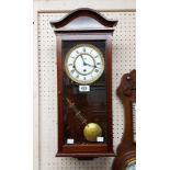 A mahogany and glazed cased wall clock with visible pendulum, dial marked for Commiti of London