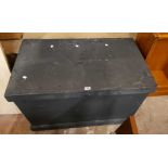 A 100cm old black painted oak lift-top trunk with flanking iron drop handles and plinth base