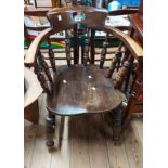 A vintage smoker's bow elbow chair with moulded solid elm seat, set on turned supports - some