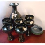 A Knights Tintagel Pottery wine set comprising carafe and six tall goblets each with black lustre