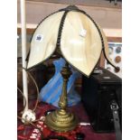 A cast brass table lamp of candlestick form with acanthus leaf decoration - sold with shade