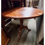 A modern stained wood pedestal table - sold with a pine similar and a stained wood wine table -