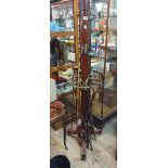 A reproduction brass mounted mahogany hat and stick stand with turned pillar, retaining rail and