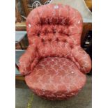 A late Victorian drawing room armchair with red floral tapestry upholstery, set on turned front legs