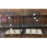 A pair of modern black painted metal and wicker work ten bottle wine racks with central carrying