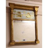 A small Regency period gilt framed pier mirror with decorative reverse gilded floral swag glass