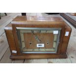 A 1930's walnut and ebony strung cased mantel clock with English eight day chiming movement