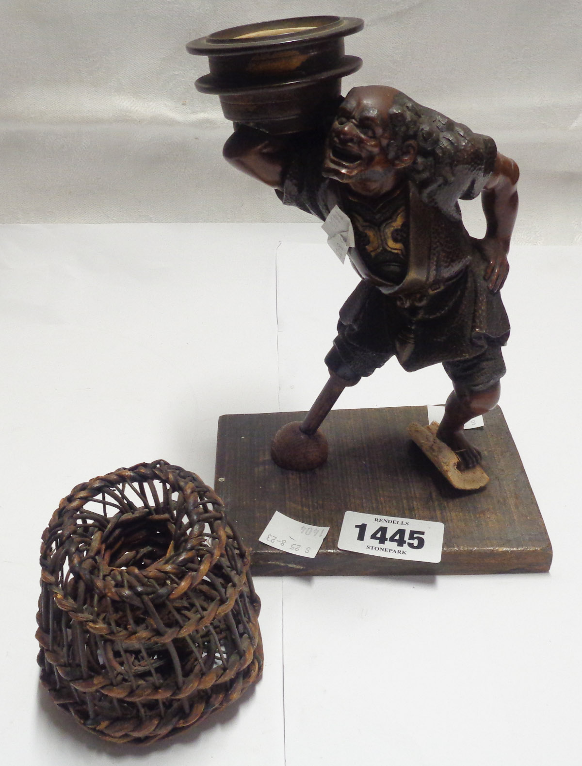 A Japanese Meiji period bronze figural candlestick depicting a sailor with later adapted replacement