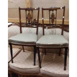 A pair of Edwardian inlaid rosewood bedroom chairs with upholstered seats