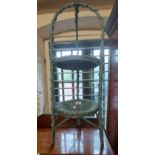 A blue painted wicker and cane two tier stand