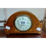 An Edwardian inlaid oak cased small timepiece with Arabic numerals and French movement