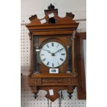 A late 19th Century inlaid mahogany cased cuckoo wall clock with flanking barley twist columns to