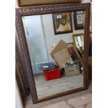 A modern gilt framed bevelled oblong wall mirror with decorative border