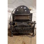 A vintage Selling & Co. electric fire with metal fire grate style body and gothic decoration - for