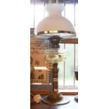 A Victorian oil lamp with cut glass reservoir, set on a brass column base, with chimney and opaque