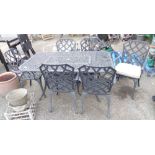 A 1.57m modern metal garden table of lattice design - sold with a set of six matching elbow chairs