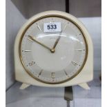 A vintage Smiths white bakelite cased mantel clock with floating balance and eight day gong striking