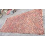 An old handmade wool on cotton rug with repeat geometric design within a single border on russet