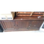 A 1.48m early 20th Century oak and mixed wood three door cupboard