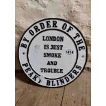 A modern painted cast iron 'Peaky Blinders' sign