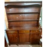 A 1.4m vintage mahogany Stag two part dresser with two shelf open plate rack over a base with