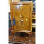 A 1930's walnut pot cupboard set on cabriole legs with pad feet